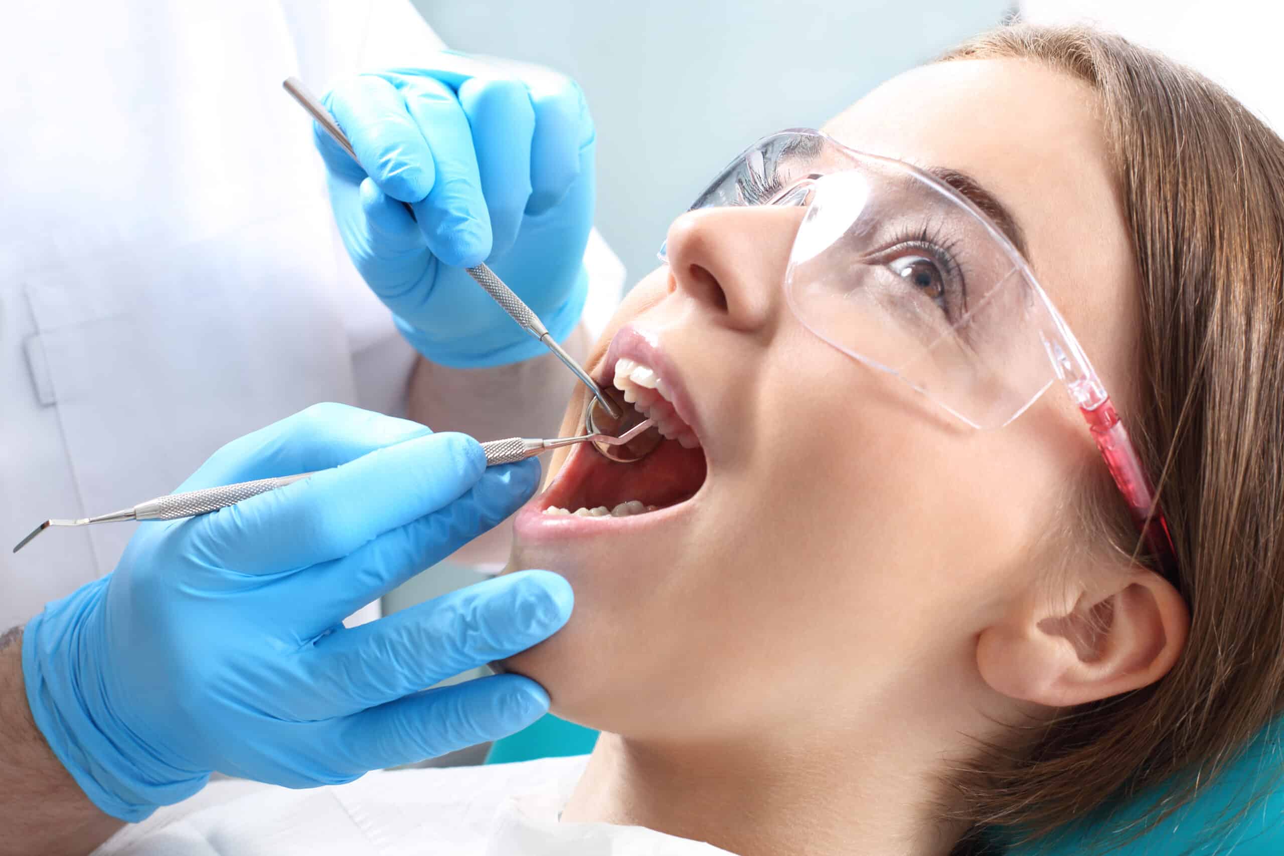 Dentist performing checkup on a girl